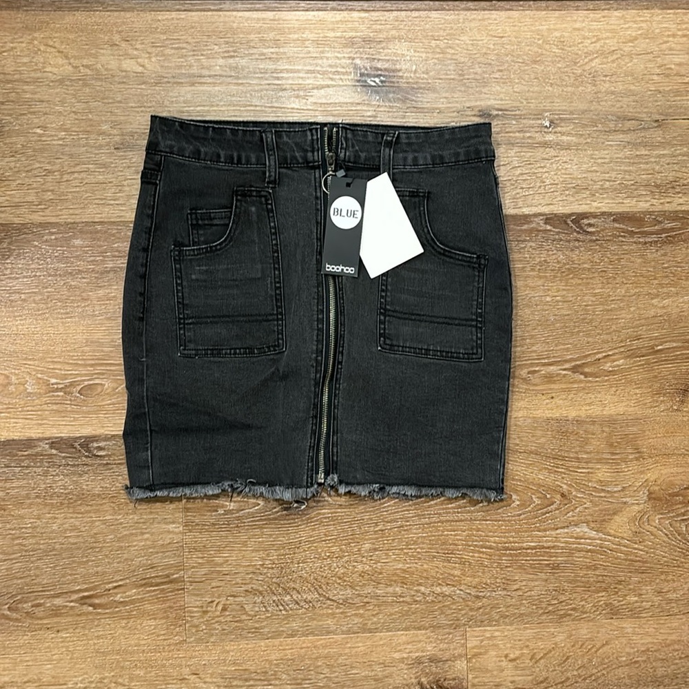US size 6 Boohoo black denim mini skirt with raw hem. Never worn with tags.